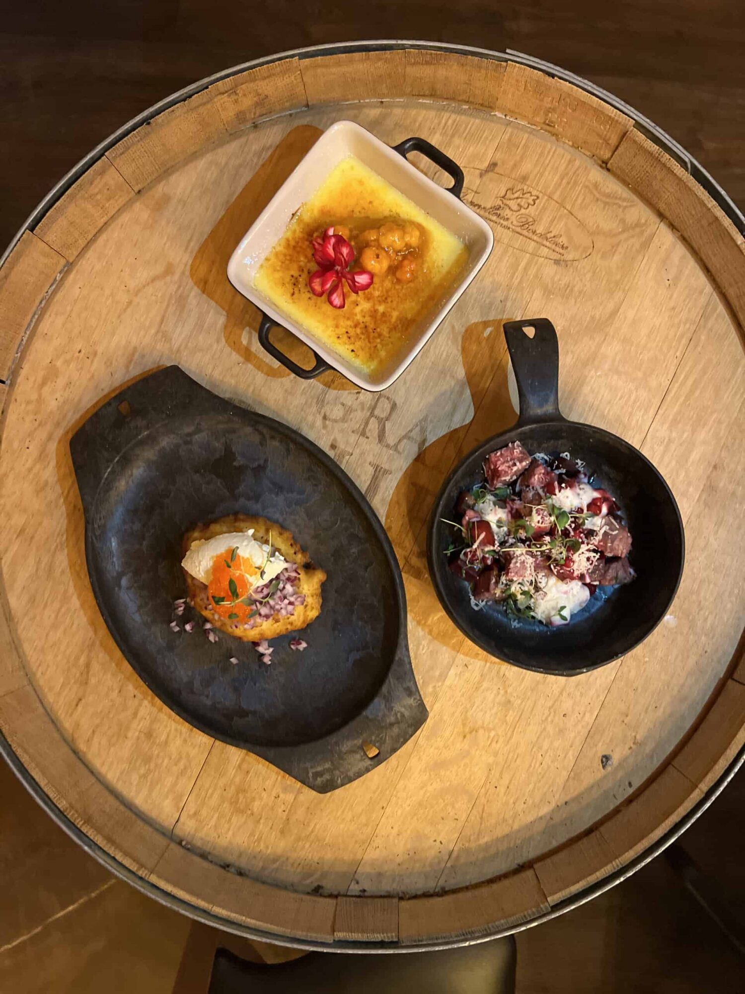 Assorted gourmet dishes served on a wooden table at Aurora Sea Resort.